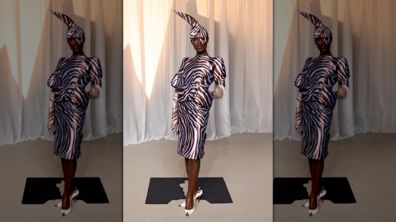 Jodie Turner-Smith poses in a striped dress