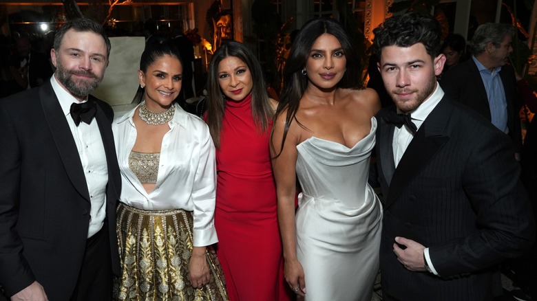 Priyanka Chopra and Nick Jonas posing with others