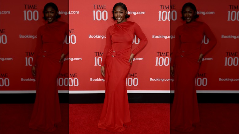 Isan Elba in a long-sleeve red gown