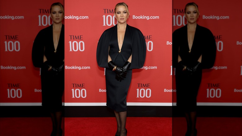 Kate Hudson in a black dress with built-in cape