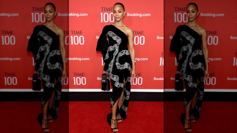 Zoe Saldaña wears a one-shoulder black dress with lace