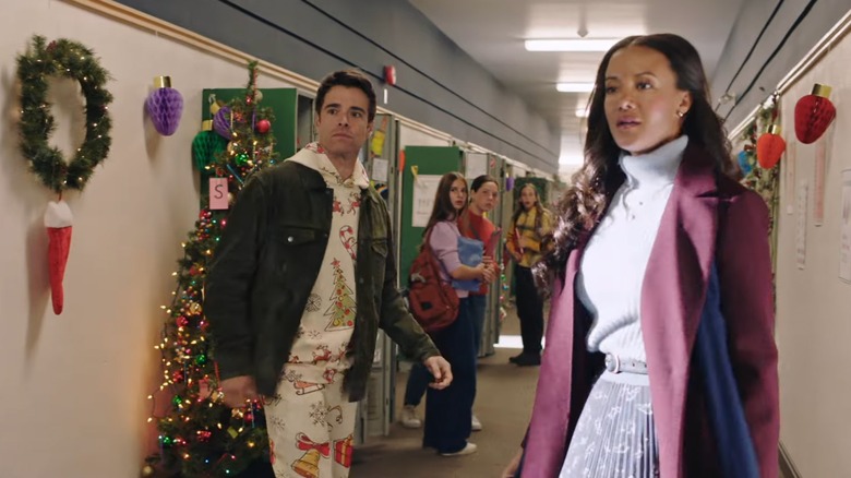 Heather Hemmens and Corey Cott standing in a school hallway