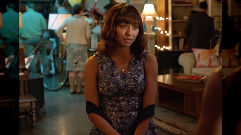 Kat Graham talking while wearing a sparkly dress