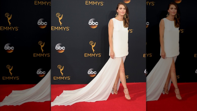 Keri Russell wears a white dress and heels