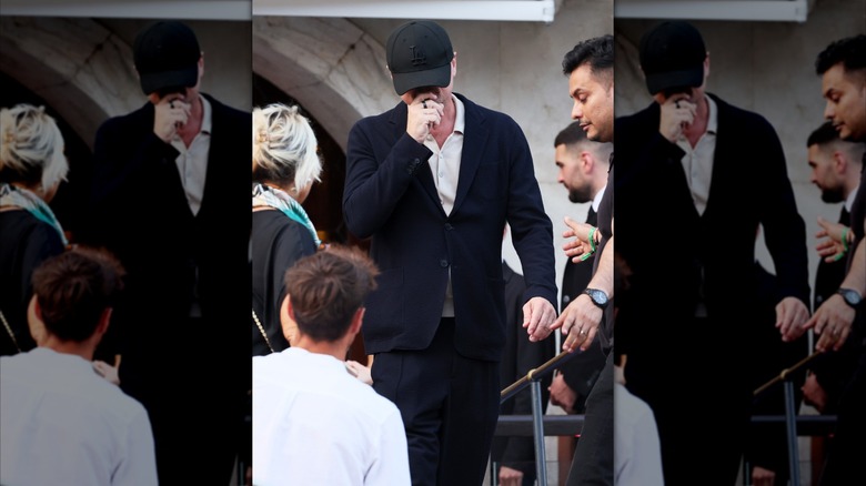 Leonardo DiCaprio wearing baseball cap over his face