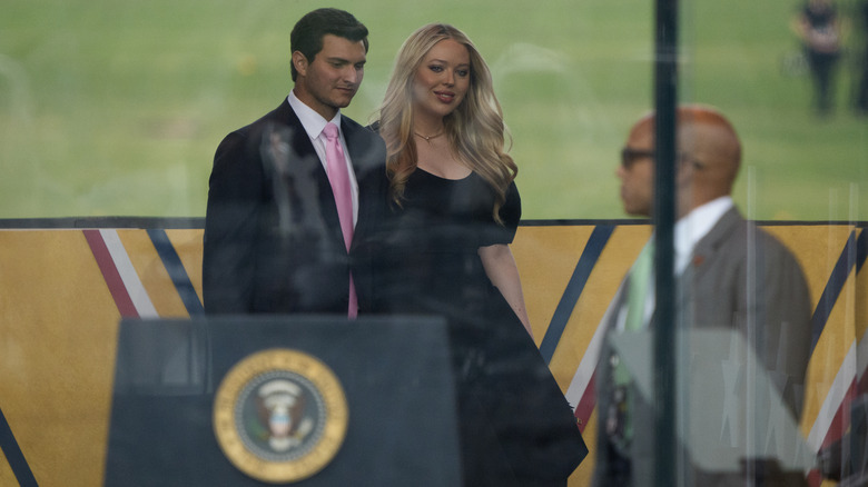 Tiffany Trump in a puff sleeved dress walking on stage at the 2025 military parade
