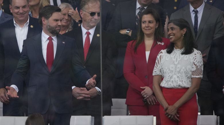Usha laughing at JD Vance on the stage at the 2025 military parade