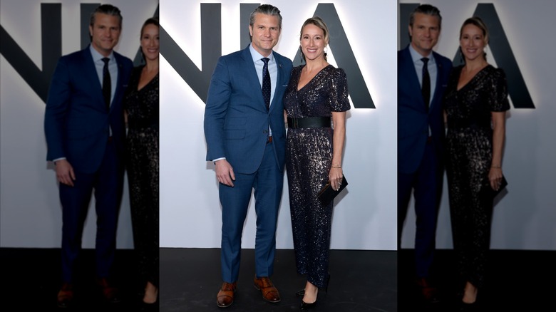 Pete Hegseth wearing a blue suit and Jennifer Rauchet wearing a black and silver dress at the "Melania" premiere.