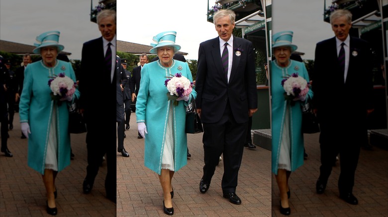 Queen Elizabeth II at Wimbledon walking with man