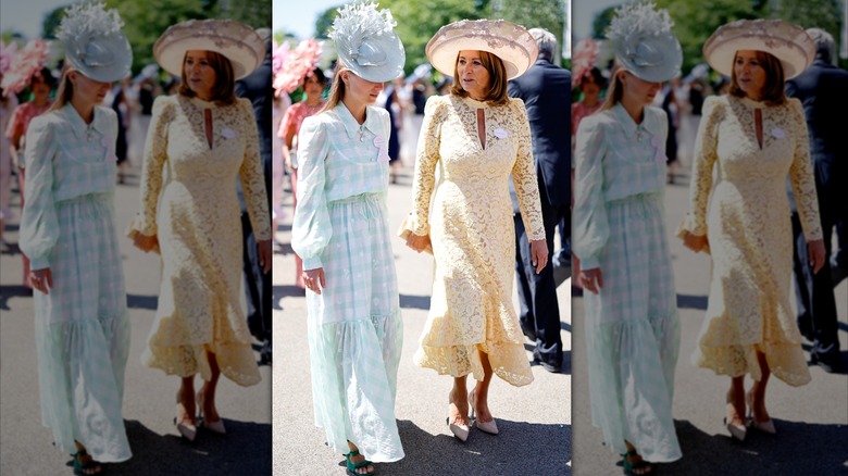 Alizee Thevenet in long, blue checkered dress with puffy sleeves, collar, and ruffle hem and blue feathery hat, standing next to Carole Middleton