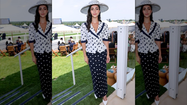 Ellie Evelyn Smith wearing navy blue and white polka-dot hat, top, and skirt