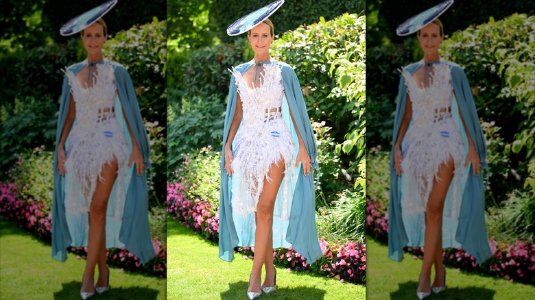 Lady Victoria Hervey in white, tight, short, feathery outfit with blue cape