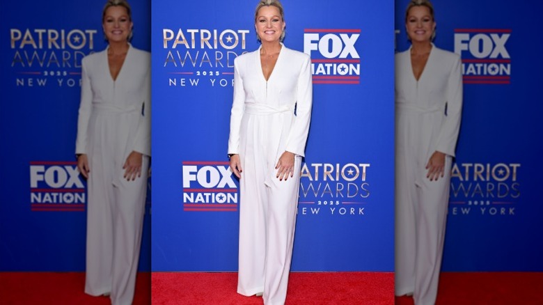 Sandra Smith in a white jumpsuit on the red carpet.