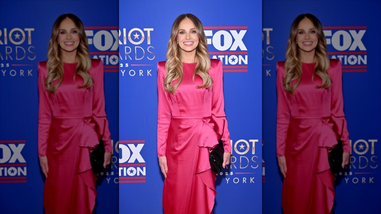 Tomi Lahren in a pink satin dress on the carpet.