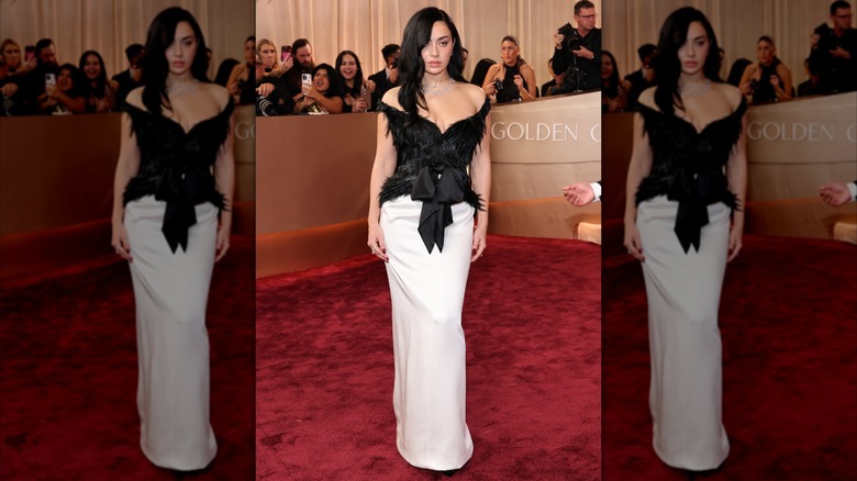Charli XCX wearing a full-length dress with a white skirt and furry black bodice