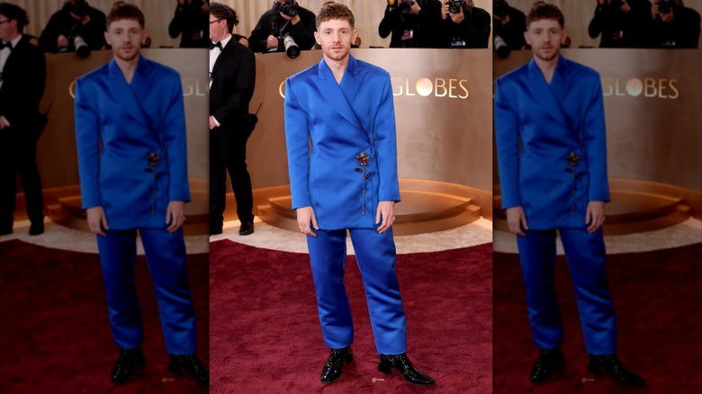 Chris Perfetti wearing a bright blue suit with a rose detail