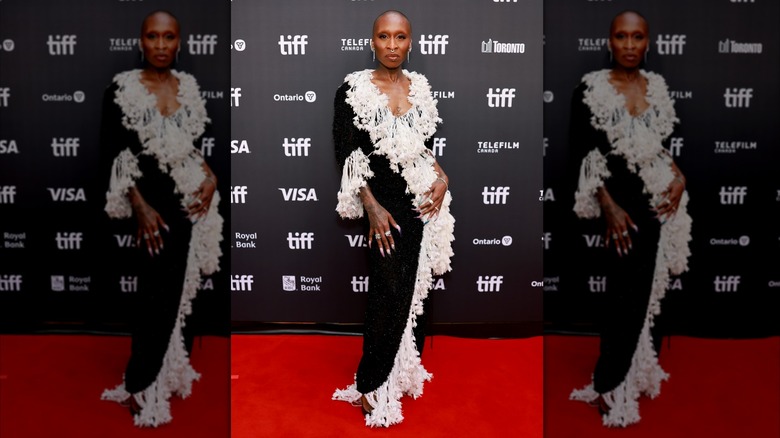 Cynthia Erivo poses on the red carpet in a black and white dress