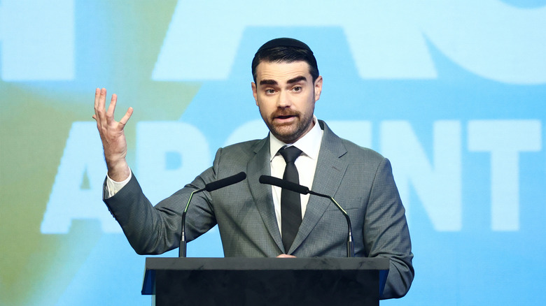 Ben Shapiro speaking to a crowd from a podium