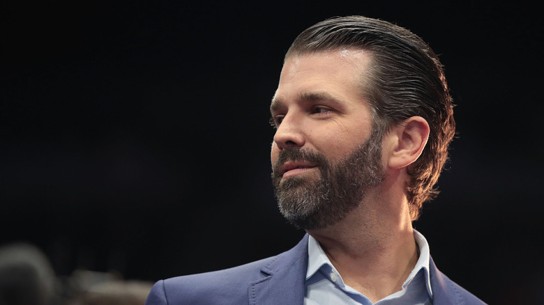 Donald Trump Jr. looking sideways and smiling
