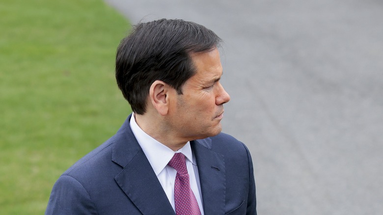 Marco Rubio looking out into distance while standing outside