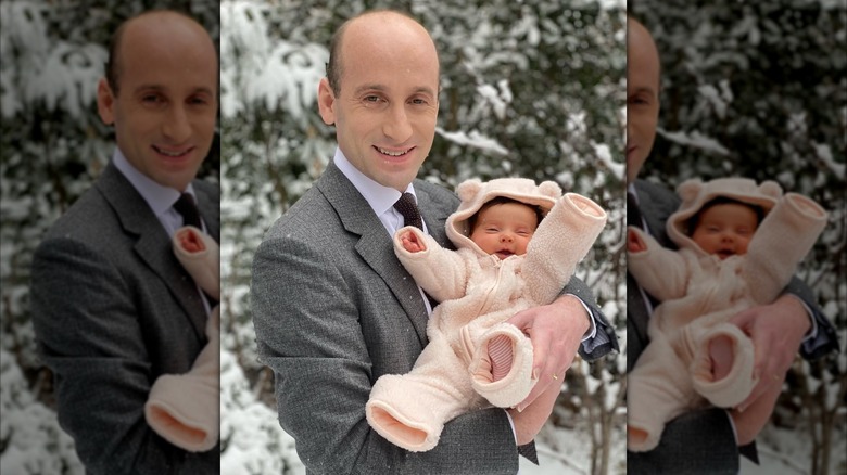 Stephen Miller holding baby in the snow