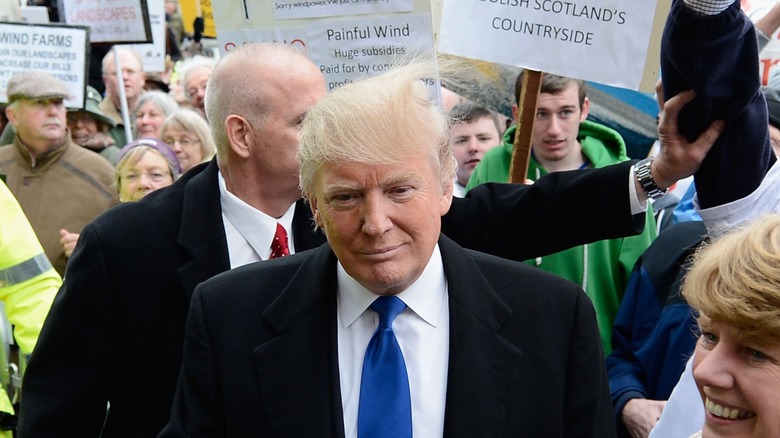 Donald Trump appears at an event in Scotland, UK, and has his hair messed up by static from a balloon
