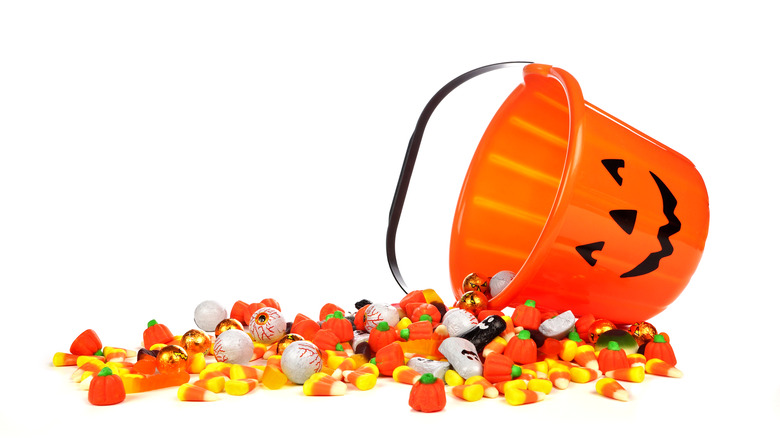 Pumpkin bucket spilling Halloween candy