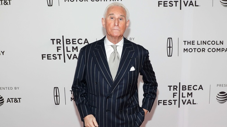 Roger Stone posing for a photo at the premiere of "Get Me Roger Stone" in 2017