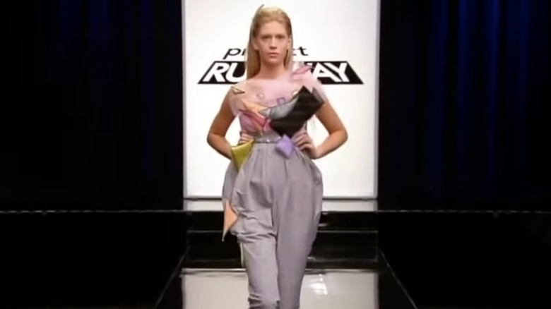 A model walks the runway wearing Brett Keeter's gray outfit adorned with various shapes