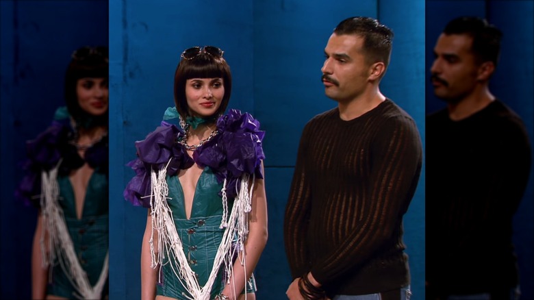 Sandro Masmanidi standing next to model in his green and purple bodysuit design