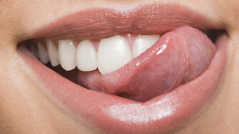 Woman licking lips