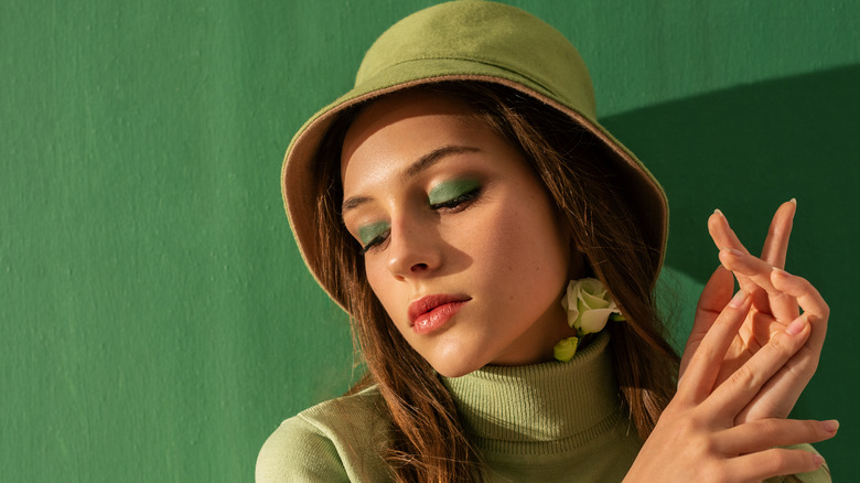 Woman with a green bucket hat