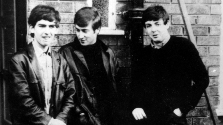 George Harrison, John Lennon and Paul McCartney, stand outside McCartney's home January 1, 1960 in Liverpool, England.