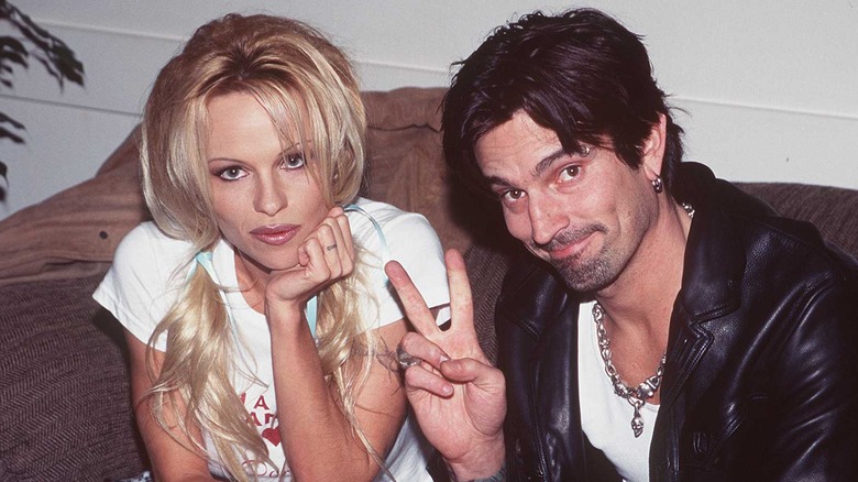 Throwback pic of Pamela Anderson and Tommy Lee posing together on a sofa