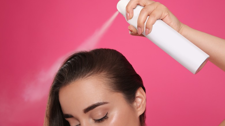 Person spraying hair