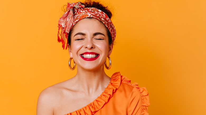 Woman in orange smiling