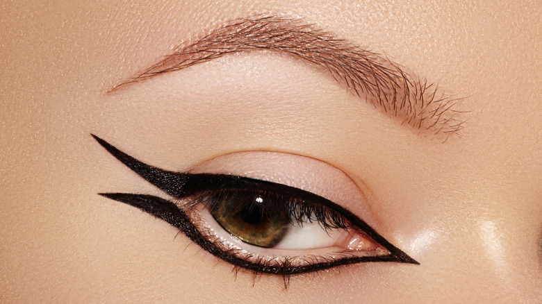 A woman wearing black graphic eyeliner. 