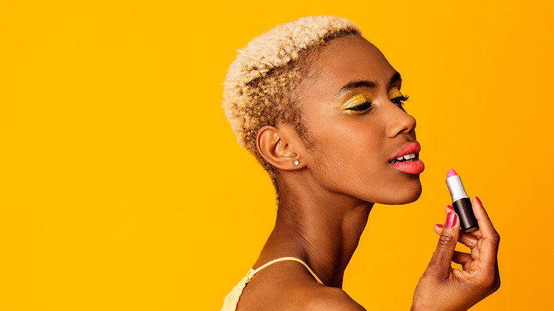 Person wearing orange lipstick with yellow eyeshadow