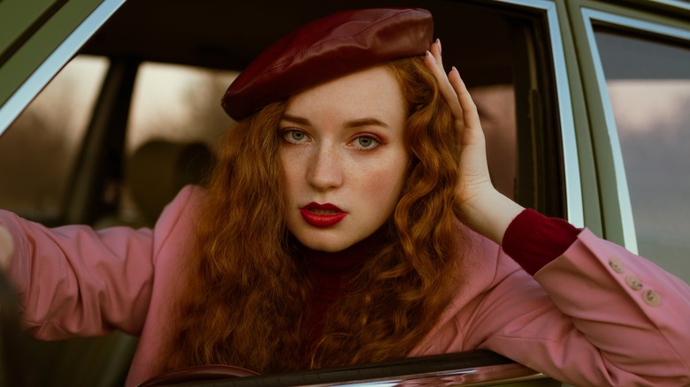 woman with wavy red hair and red lipstick