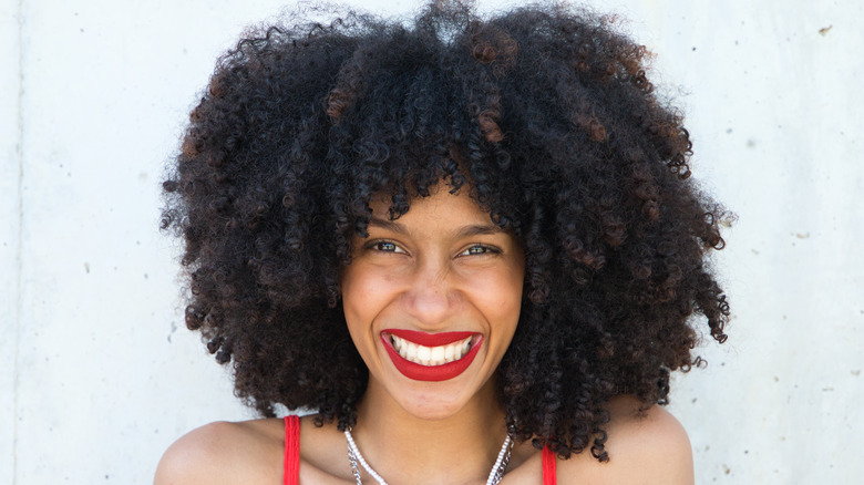 Woman smiling in red lipstick 