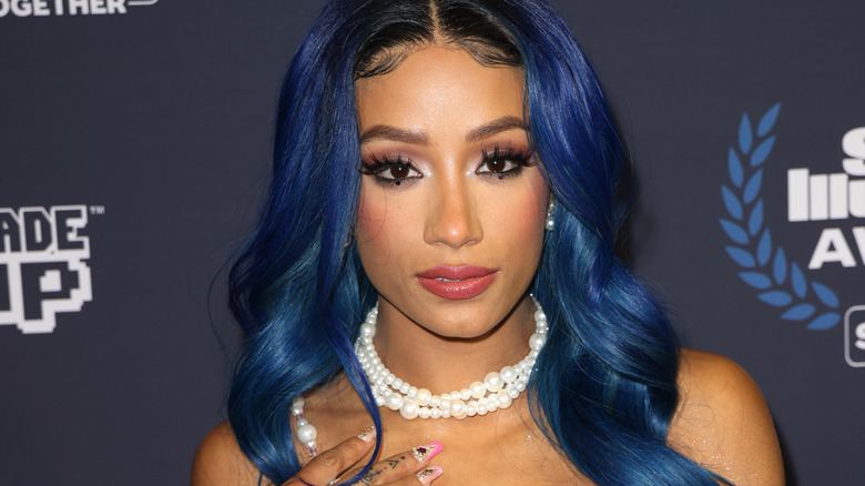 Sasha Banks with blue hair on red carpet