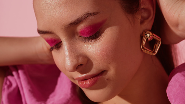 A woman wearing pink eyeshadow 