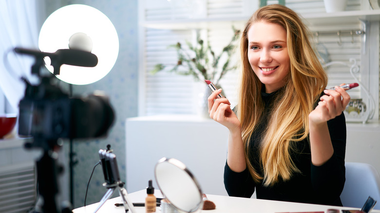 Vlogger woman filming makeup tutorial
