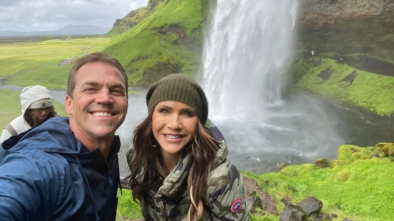 Bryon and Kristi Noem pose by a waterfall