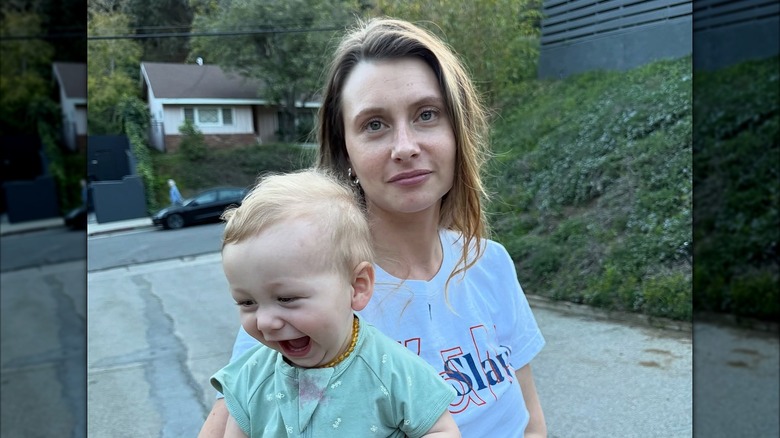 Smiling Aly Michalka and laughing Jack Francis posing on the street
