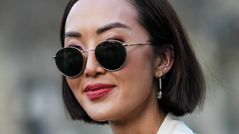 Woman smiling in sunglasses outside
