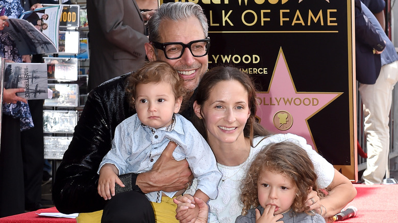 Jeff Goldblum and Emilie Goldblum smiling with their two children