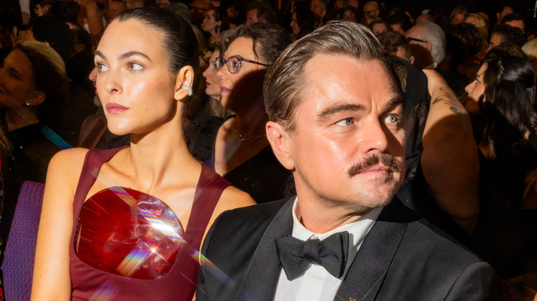 Leonardo DiCaprio and Vittoria Ceretti sitting at Oscars