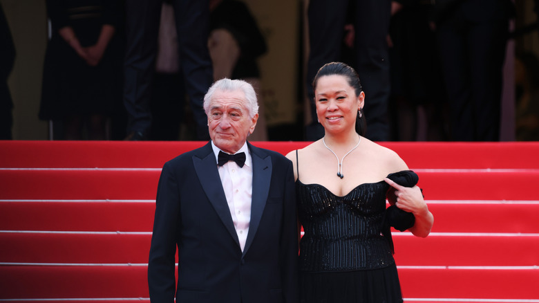 Robert De Niro and Tiffany Chen wearing black and posing