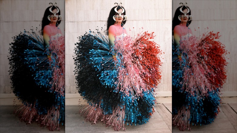 Björk posing in a colorful, 3D outfit resembling a heart